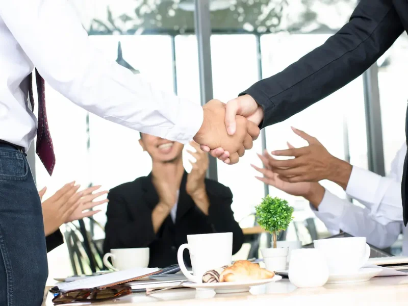 businessmen-shake-hands-with-applause-and-smiles-2025-01-08-00-05-49-utc